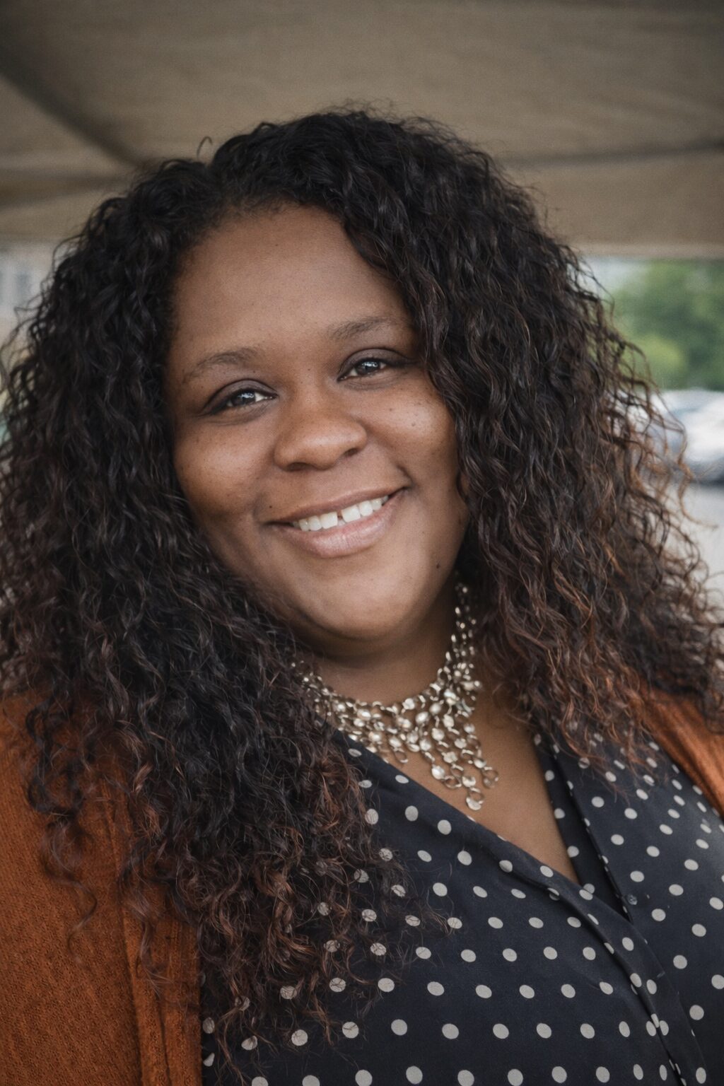 Professional testimonial portrait of a satisfied Driveway Doctor customer, smiling after a positive mobile auto repair experience
